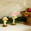Velvet mushrooms on table with garland and footed bowl with fruit on table