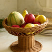 Fruit bowl with fruit on counter.