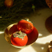 Persimmon ornaments in brass  bowl.