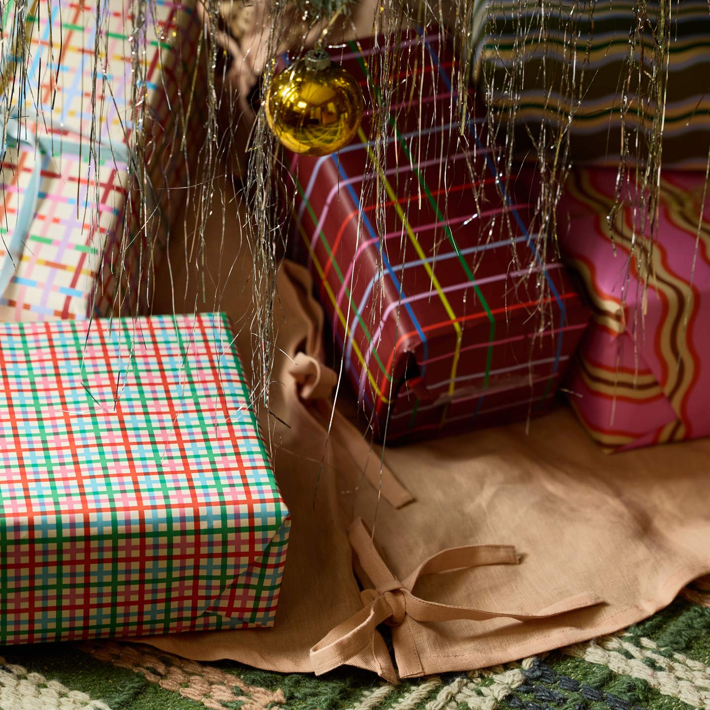 Simple linen tree skirt under tree with presents