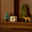 Bottlebrush trees on mantle with ornaments