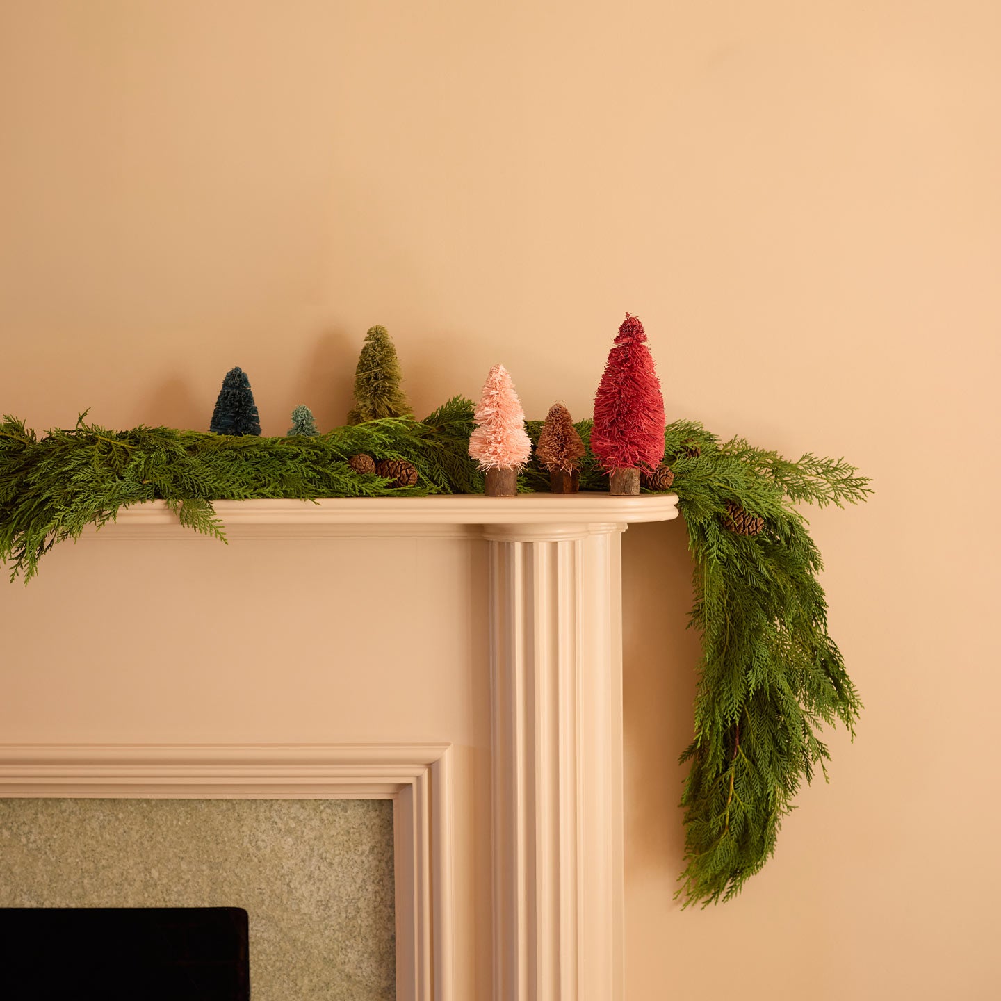 Bottlebrush trees on mantle with  garland