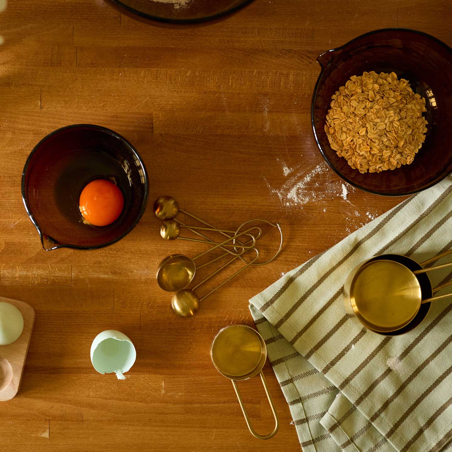 Baking set on wooden counter with towel.