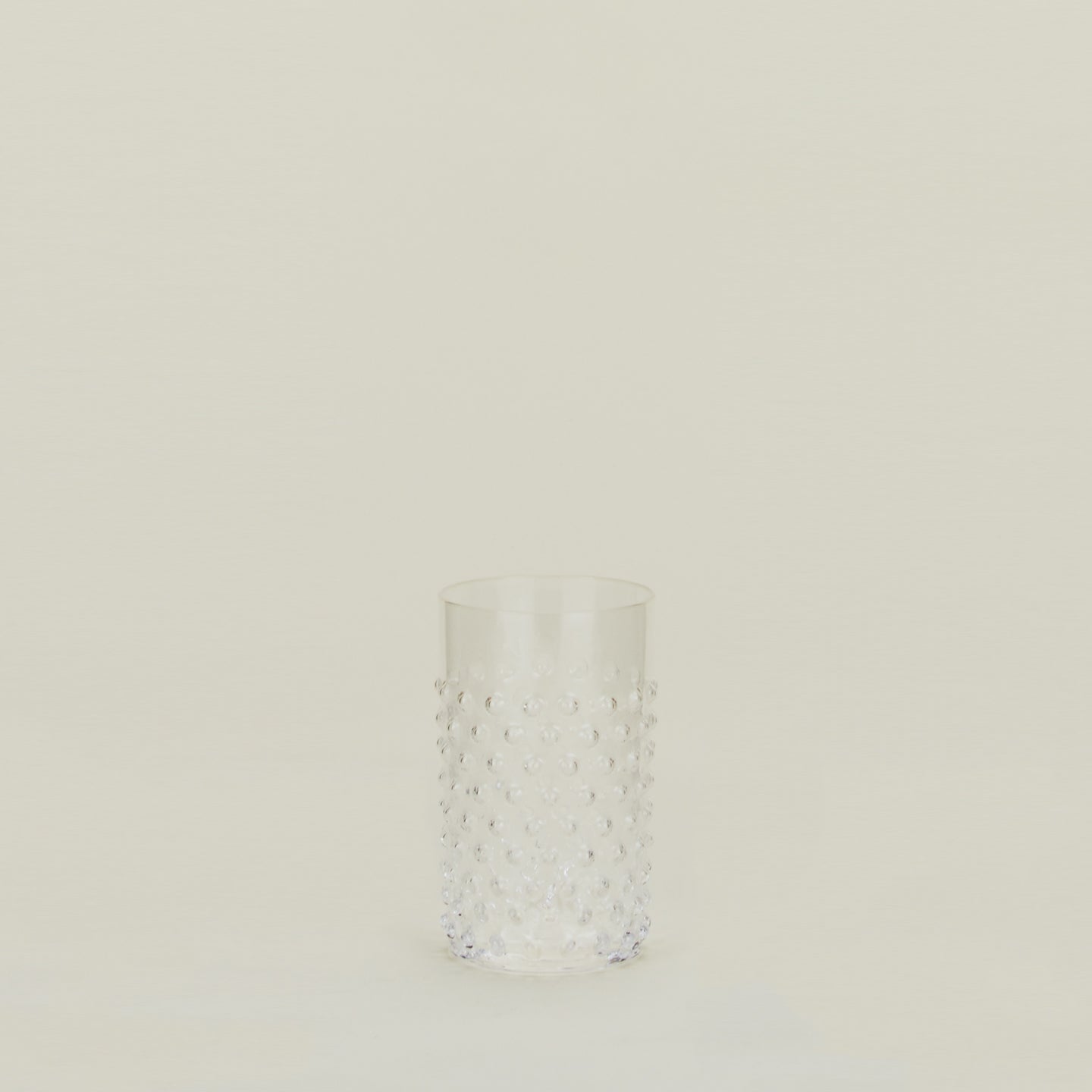 Textured clear glass tumbler.