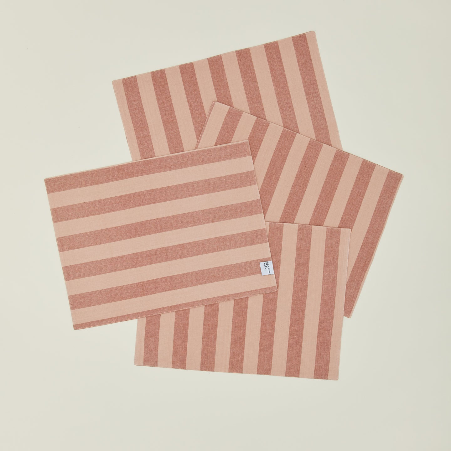 Set of four Essential Striped Placemats in Blush and Terracotta.