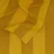Close up of Essential Striped Tablecloth in Mustard and Bronze.