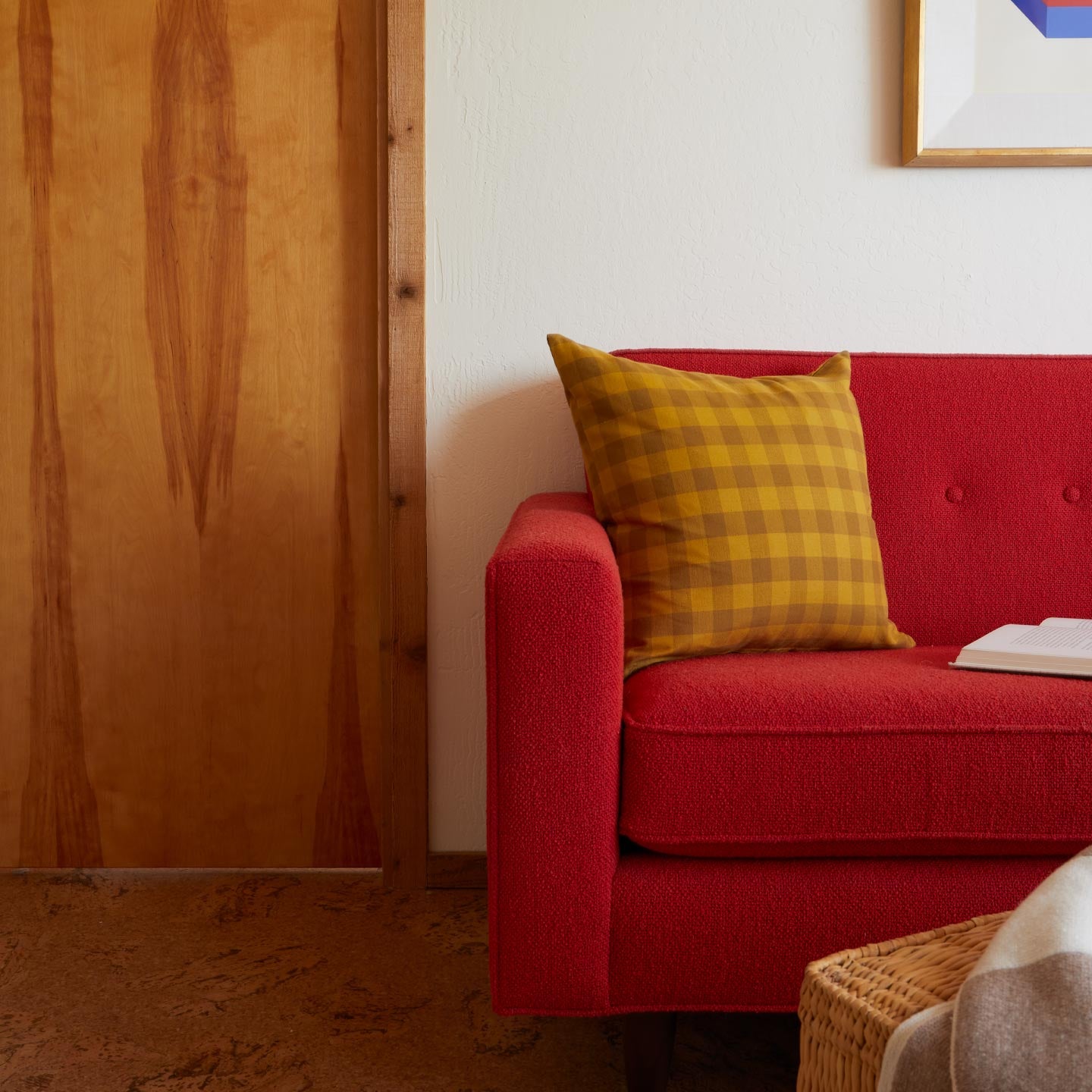 Red sofa in room with Essential Gingham Pillow in Mustard.