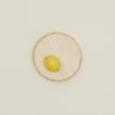 Overhead of small wood chopping block with lemon