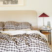 Essential Gingham Bedding in Black with nightstand and Essential Glass Pitcher in Smoke.