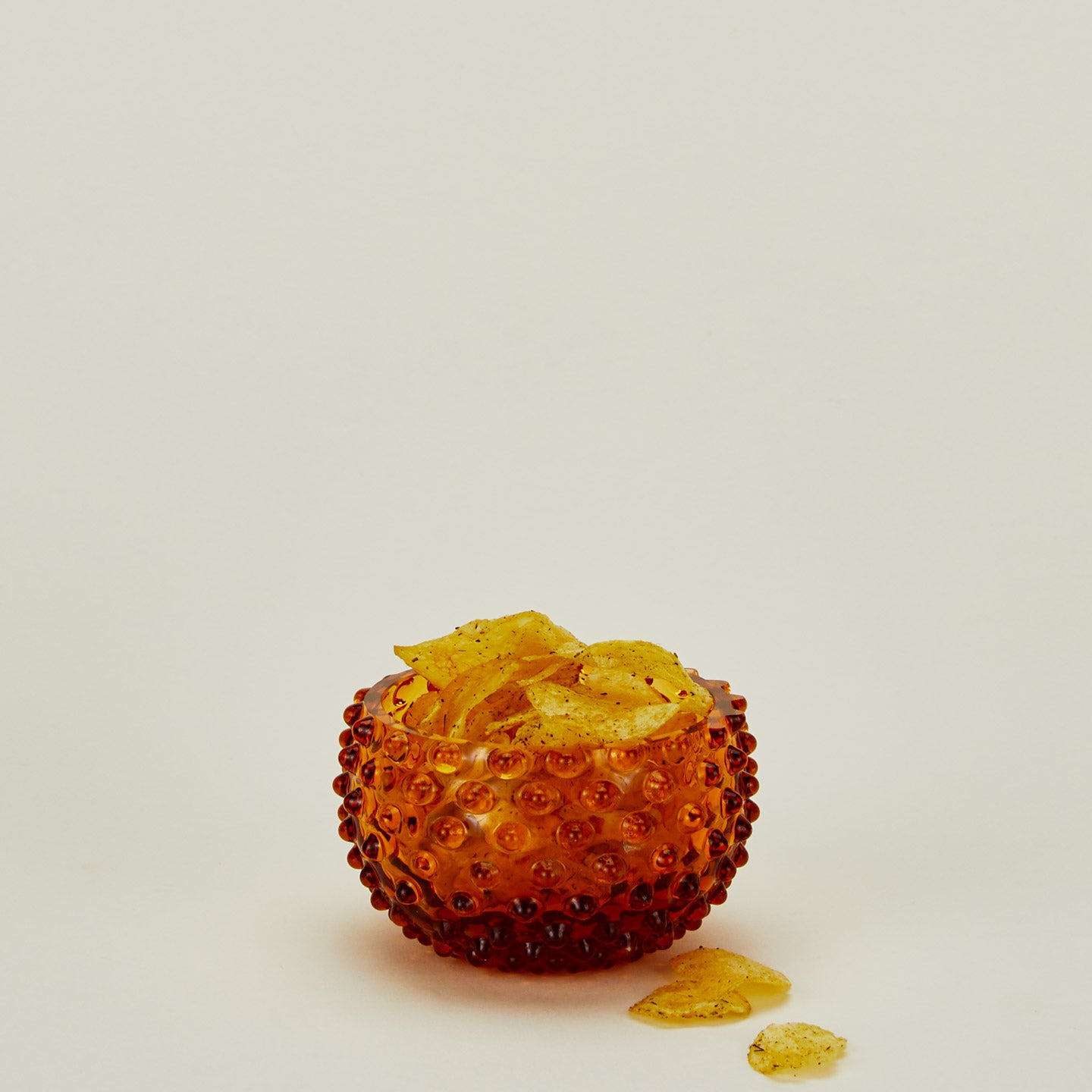 Glass hobnail amber tapas bowl with chips.