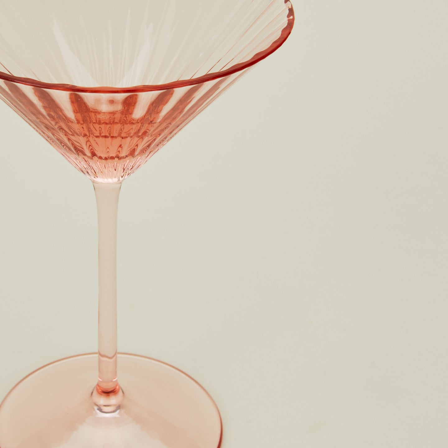 Close up of ribbed blush martini glass.
