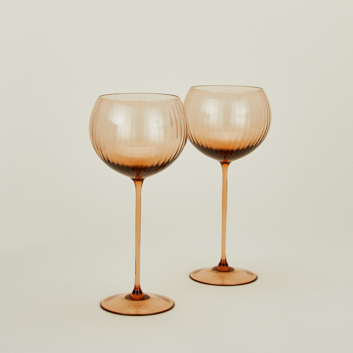 Set of two ribbed brown wine glasses.
