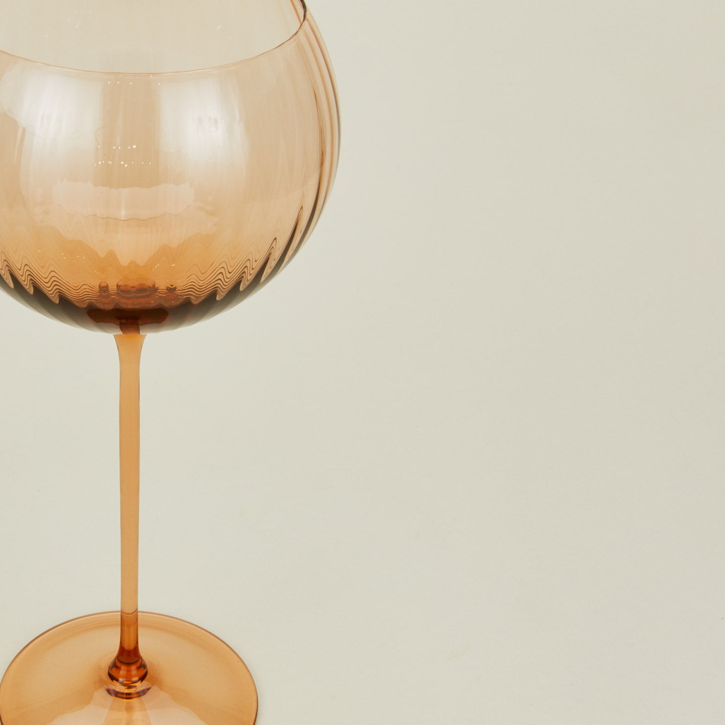 Close up of ribbed brown wine glass.
