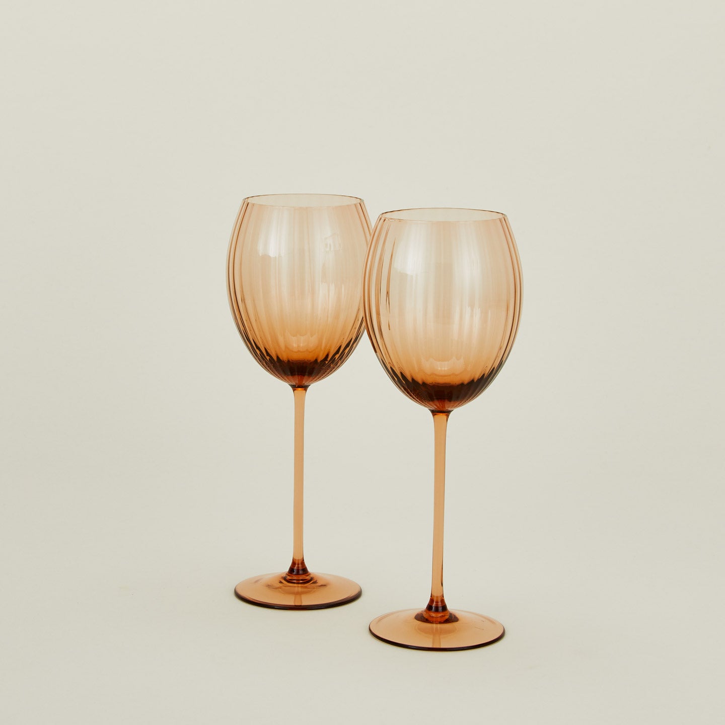 Set of two ribbed brown wine glasses.