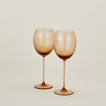 Set of two ribbed brown wine glasses.
