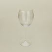 Three-quarter angle of ribbed clear wine glass.