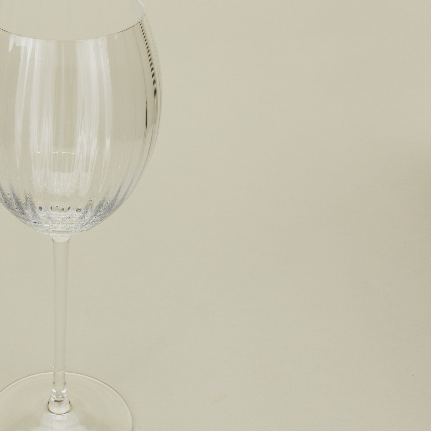 Close up of ribbed clear wine glass.