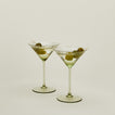 Set of two ribbed olive martini glasses with cocktail.