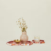 Set of two hexagon marbled trays in warm tones with vase, footed bowl, and scented candle.