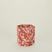 Marbled hexagon wastebasket in warm tones.