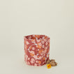 Marbled hexagon wastebasket in warm tones with balled-up paper.