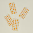 Dove and Donkey wicker fringed napkin in marigold, set of 4