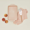 9x13 bakeware in blush with apples dish towel and spatula