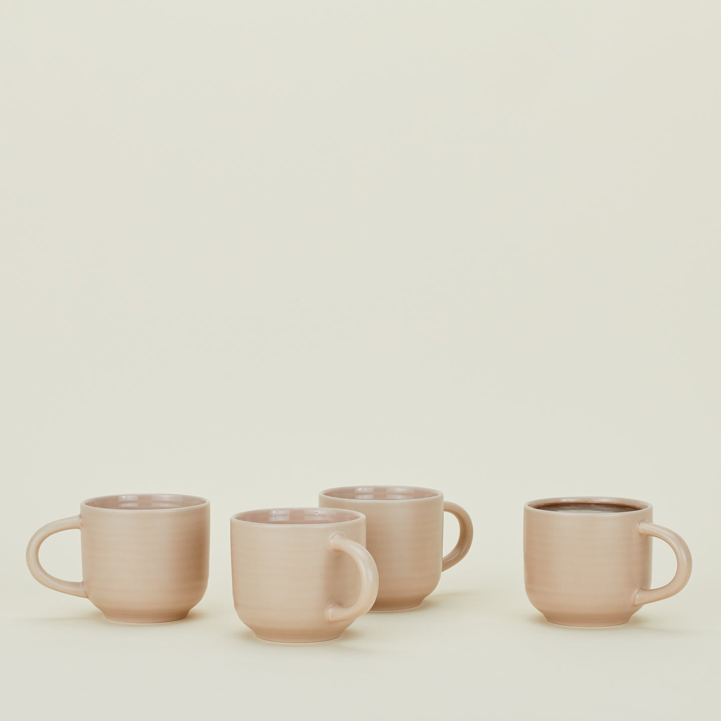 Four Essential Mugs in Blush, with coffee.