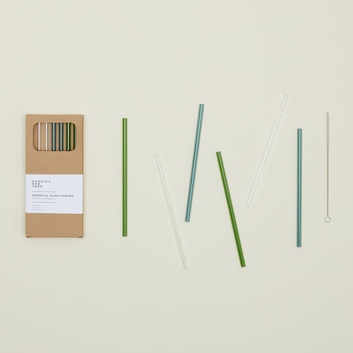 Kraft colored gift box of Essential Glass Straws in Cools, with straws scattered nearby.