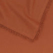 Close up of Essential cotton tablecloth in terracotta.