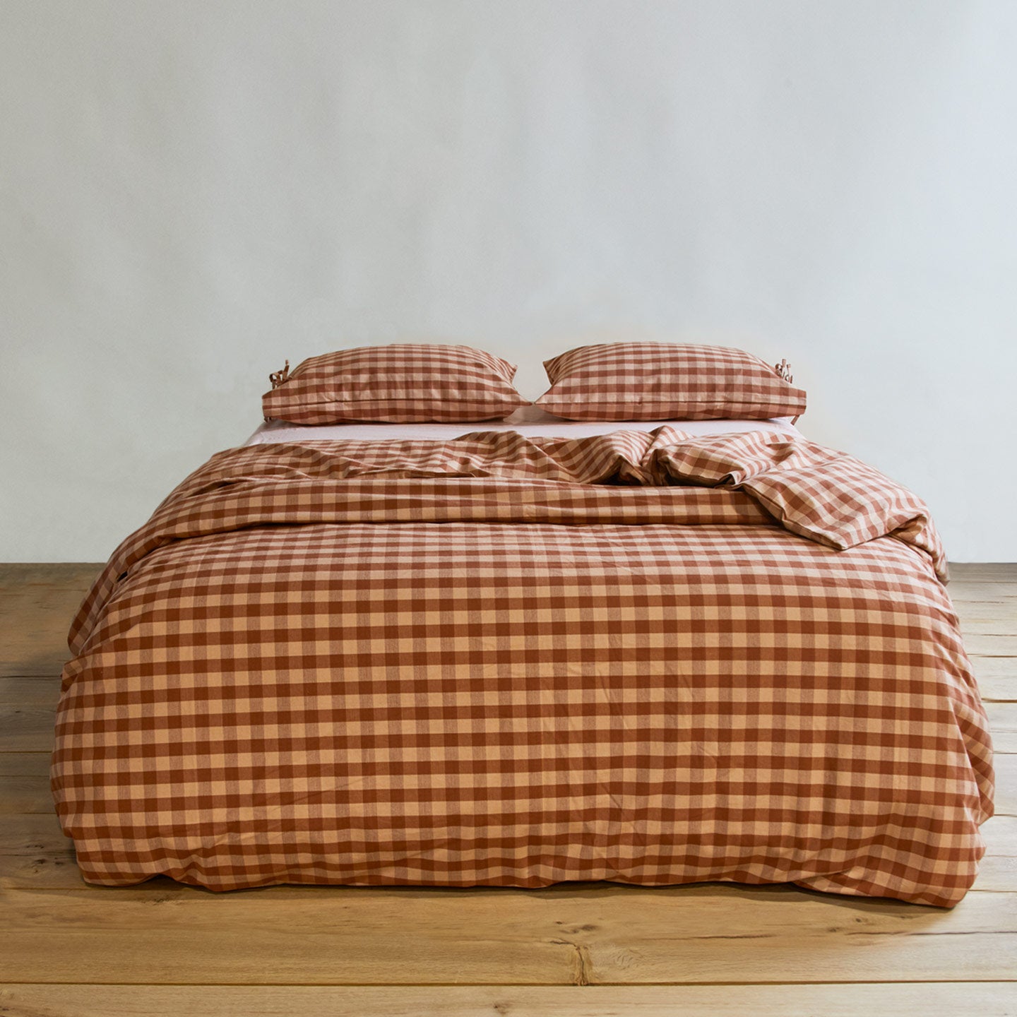 Essential Gingham Duvet - Blush/Terracotta on bed with matching pillow cases