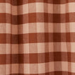 Close up view of gingham shower curtain in blush/terracotta