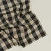 Close up view of Essential Gingham napkin in black/grey