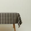 Essential Gingham tablecloth in grey/black on a table.