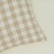 Close up view of gingham square pillow in ivory/flax