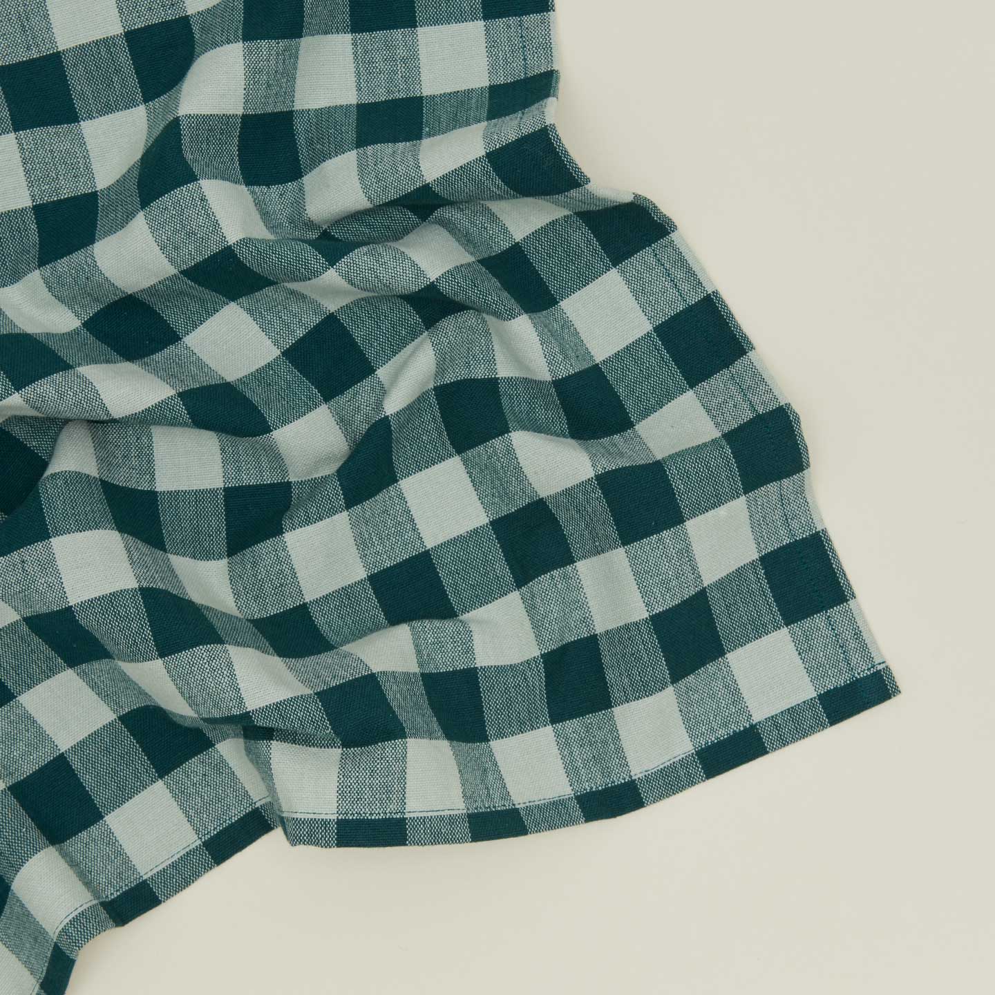 Close up view of Essential Gingham napkin in sky/peacock