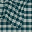 Close up view of Essential Gingham tablecloth in sky/peacock