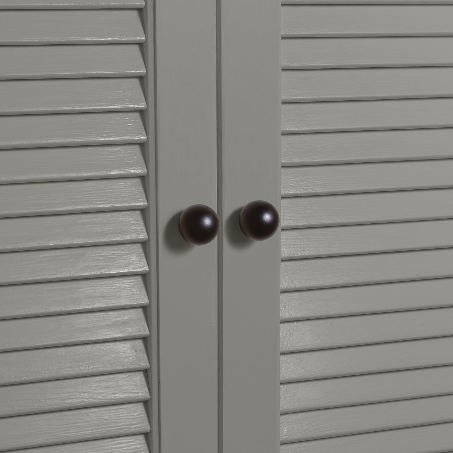 Small black essential sphere knobs on louvered doors