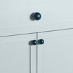 Large and small peacock essential sphere knobs on drawers and cabinets