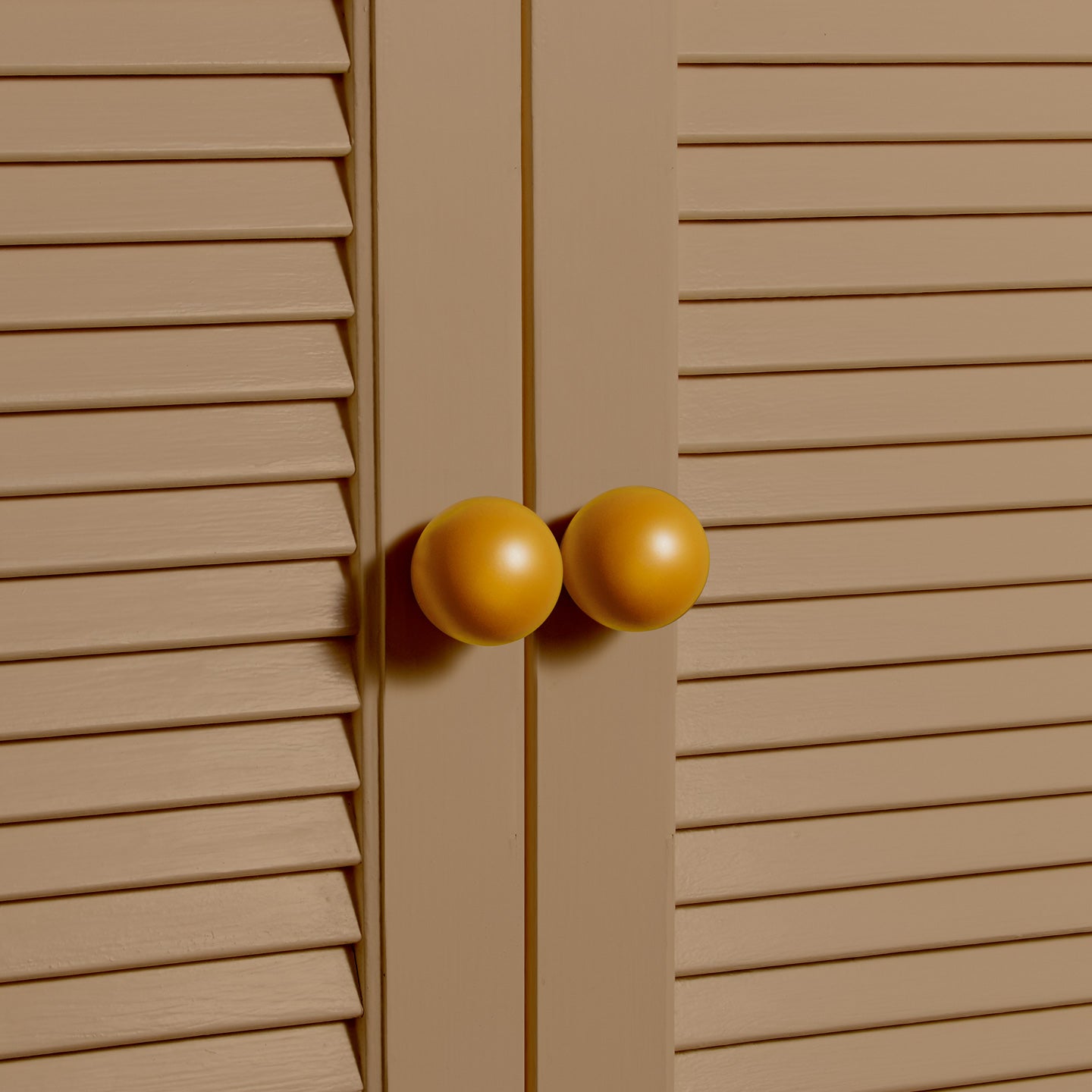 Large mustard essential sphere knobs on louvered doors