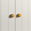 Large mustard essential sphere knobs on white doors