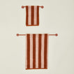 Small and large towel bars in Terracotta with striped towels.