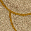 Close up view of essential woven placemat in mustard
