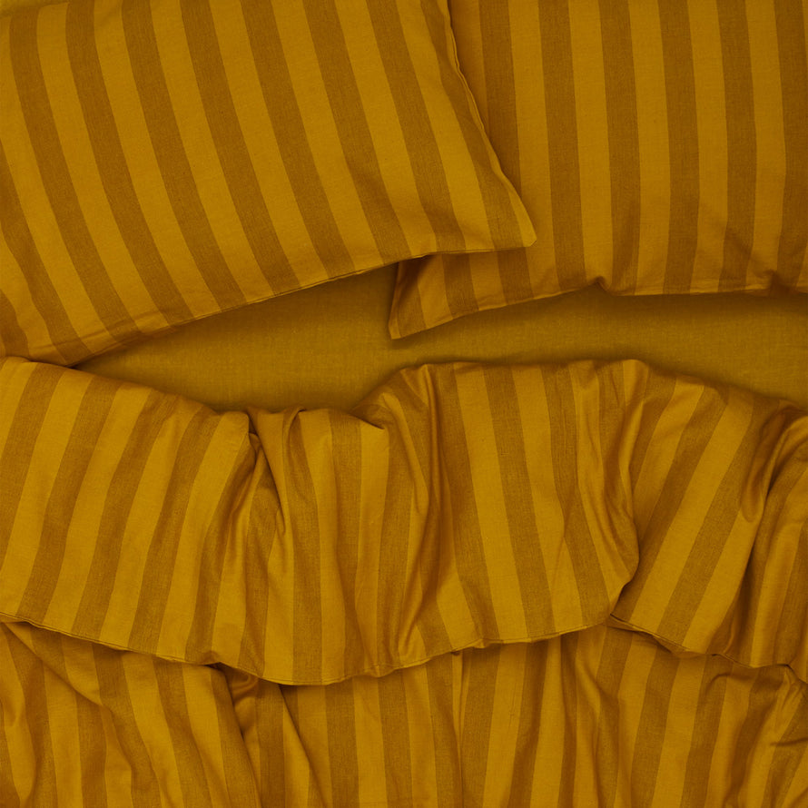 Essential Stripe Duvet - Mustard/Bronze on bed with matching pillow cases