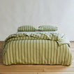 Essential Stripe Pillowcases, Set of 2 - Sage/Olive on bed with matching duvet.