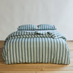 Essential Stripe Pillowcases, Set of 2 - Sky/Peacock on bed with matching duvet