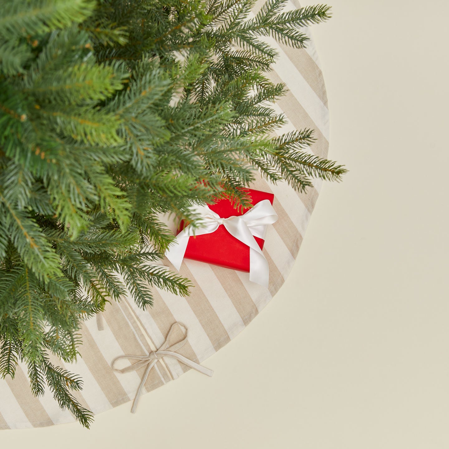 Overhead view of Essential Striped Tree Skirt - Ivory/Flax with tree