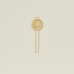 Brass swirl egg separator on ivory background.