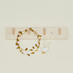 Brass leaf garland on rack with goose ornament