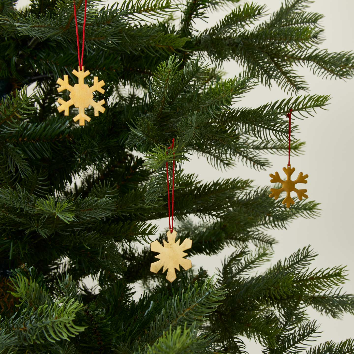 Brass snowflake ornaments set of 3 on tree